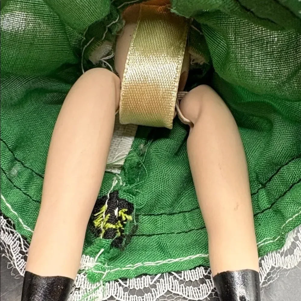 Traditional vintage porcelain doll with Green Hat and Dress